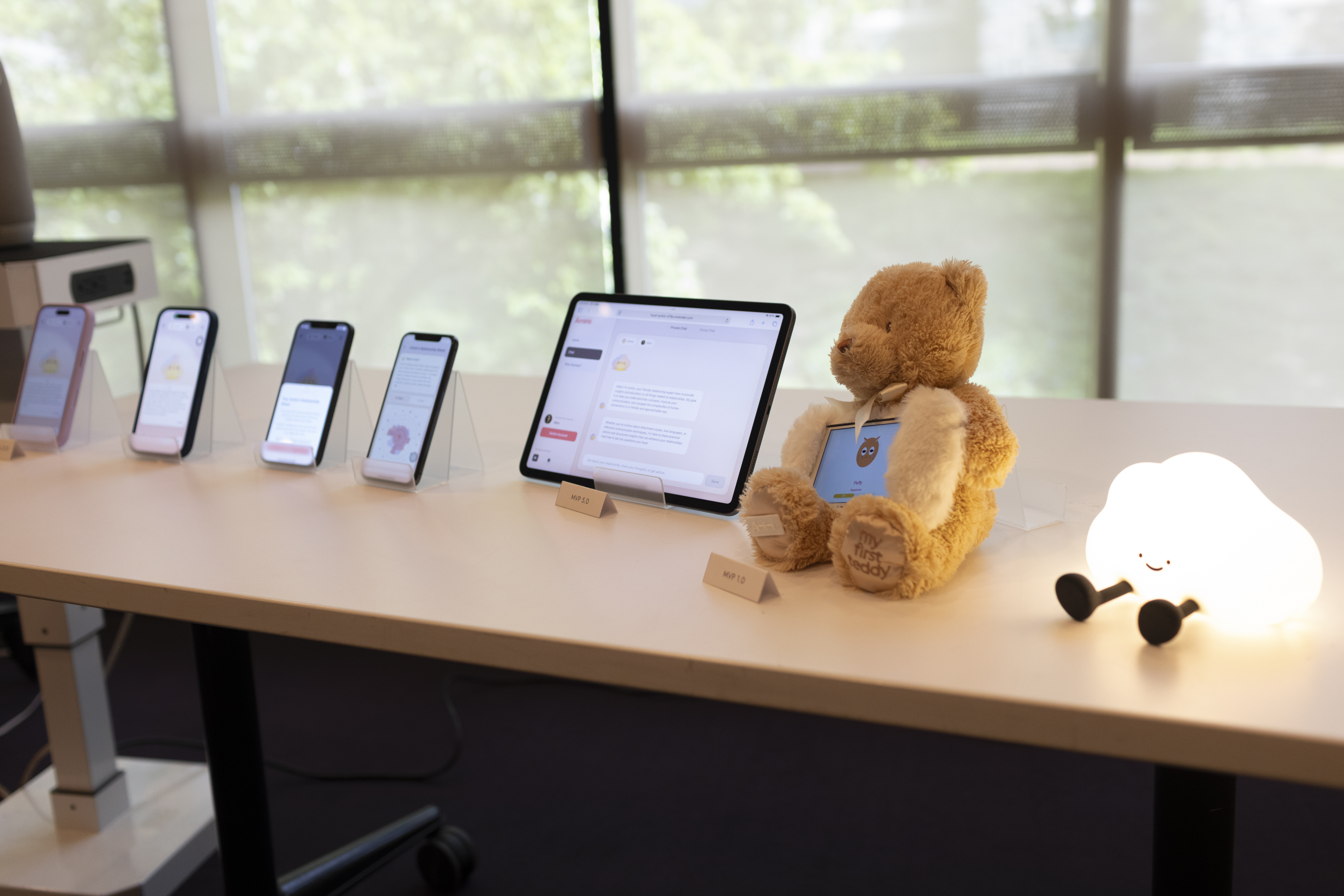 Amimi displayed across mobile phones, a tablet, a teddy-bear prototype, and an illuminated cloud character