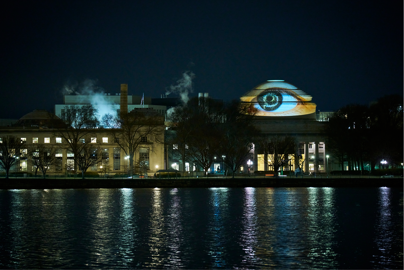 The illuminated MIT Dome viewed across the river